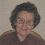 Woman with glasses, smiling