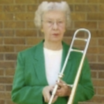 Woman holding a trumpet outside