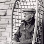 Man sitting in a chair, outside